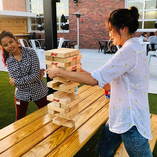 Teammates playing Jenga outdoors