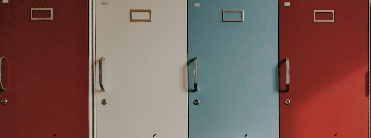 Multicolored lockers arranged in rows featuring many different colored doors