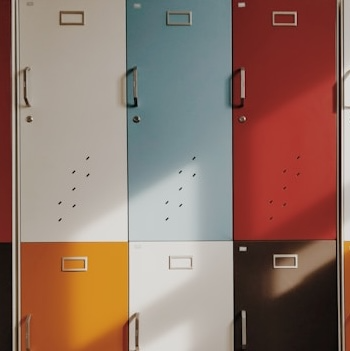 Multicolored lockers arranged in rows featuring many different colored doors