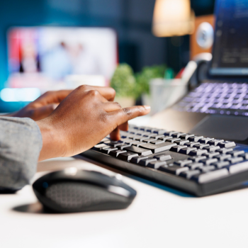 hands typing on a keyboard