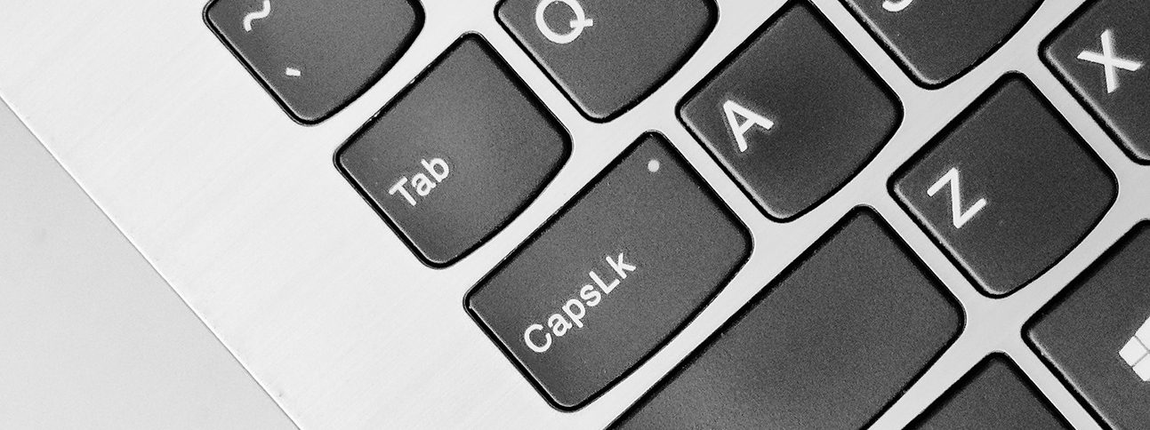 A close-up of a portion of a computer keyboard, centered on the tab key.