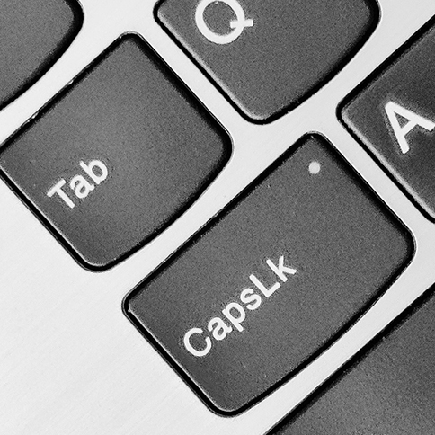 A close-up of a portion of a computer keyboard, centered on the tab key.