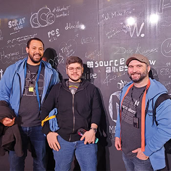 Three teammates posing for picture at AWS re:Invent 2019