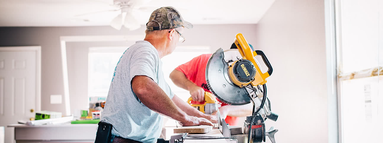 Two men sawing wood on home improvement project