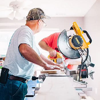 Two men sawing wood on home improvement project