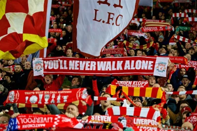 Liverpool F.C. fans holding a banner stating: You'll never walk alone