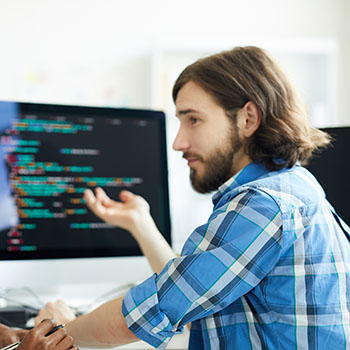 Two people discussing tests in front of a computer