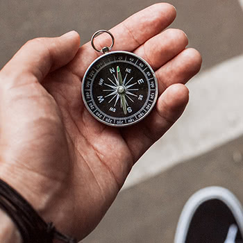 Close-up of hand holding a compass