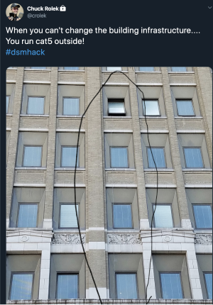 Tweet from Chuck Rolek from dsmHack showing how they ran an ethernet cable from the ground to a 5th story of a building when the WiFi went out