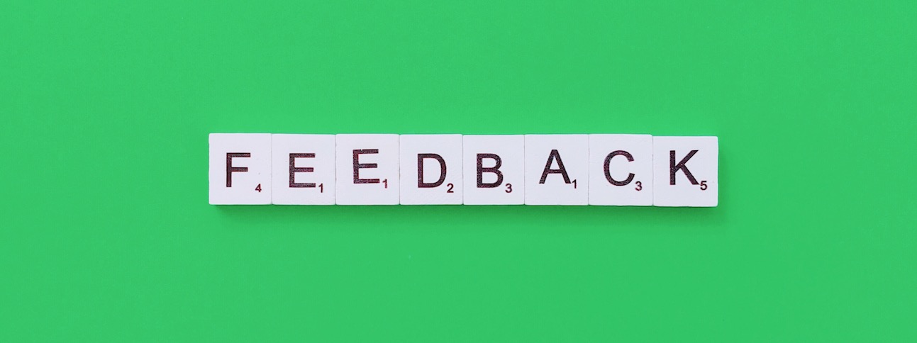 A green background with Scrabble tiles spelling out the word feedback.