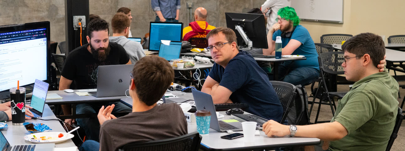 Source Allies teammates posing with their Hackathon group members