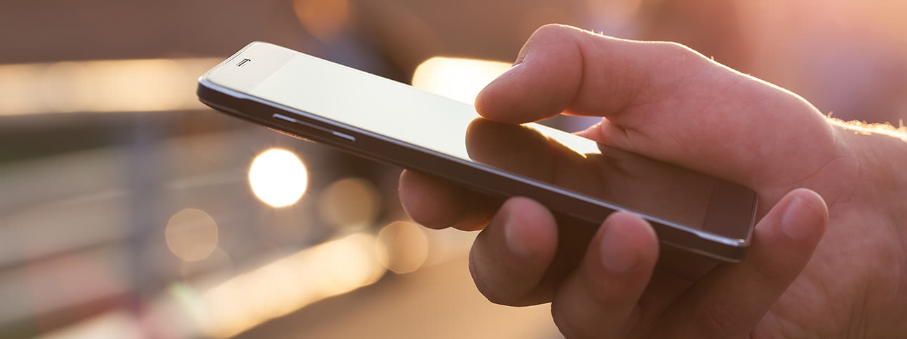 Close-up of hand holding cell-phone