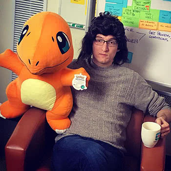 Teammate with funny wig and stuffed Charmander