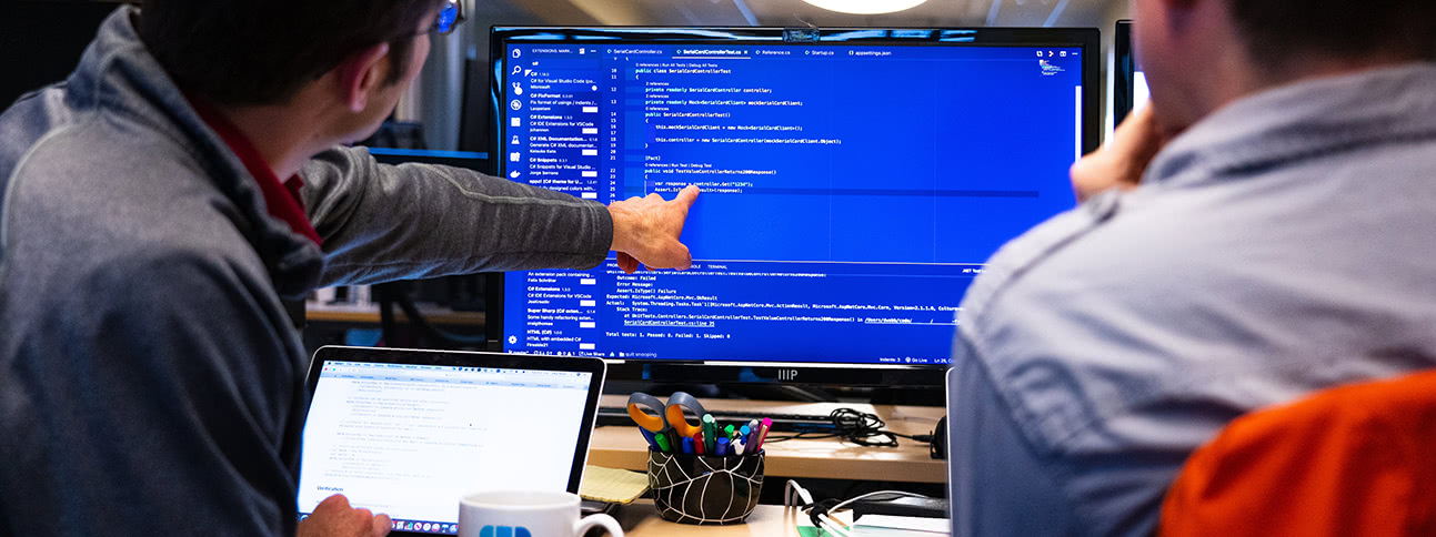 Teammate looking at code and pointing at screen